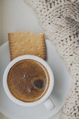 Tasty coffee espresso in small cup on grey plaid. Home concept. Top View. Toning.
