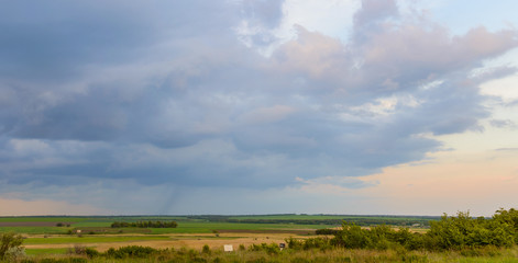 Summer landscape with dramatic sky on sunset