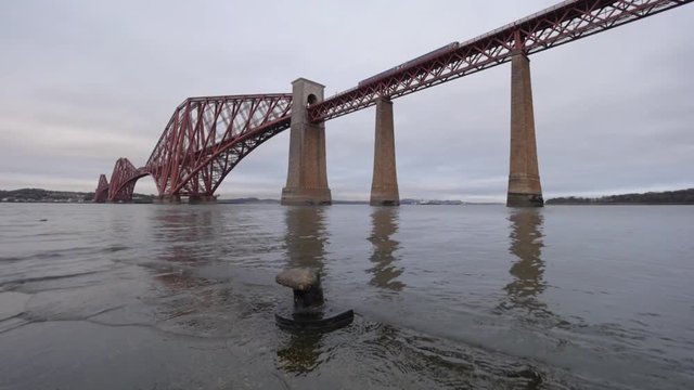 The iconic Forth Rail Bridge, a 19c. cantilever bridge spanning across the Firth of Forth bay, viewed from South-Quennsferry. Near Edinburgh, Scotland, UK 