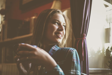 Fototapeta premium Beautiful woman enjoying in cup of coffee. Young man drinking coffee.