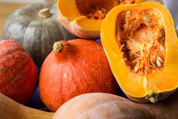 Autumnal ripened yellow, orange, green pumkins full and cut