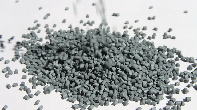 Plastic pellets . The dye granules for polypropylene polystyrene falling on a light background