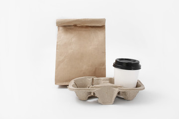 Eco-pack and stand for fast food from recyclables with a glass on a white background