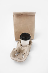 Eco-pack and stand for fast food from recyclables with a glass on a white background