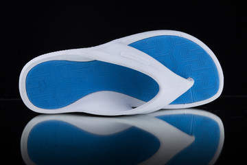 Male White and Blue Slipper on Black Background, Isolated Product, Top View, Studio.
