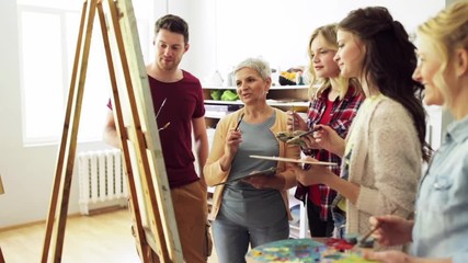 group of artists discussing painting at art school