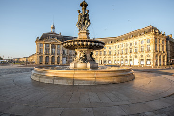 Fototapeta na wymiar View on the famous Three Graces fountain on La Bourse square during the morning in Bordeaux city, France