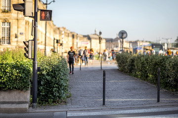 Street view with pedestrian sidewalk and traffic light in Bordeaux city, France