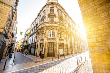 Street view with beautiful buildings during the sunrise in Bordeaux city, France