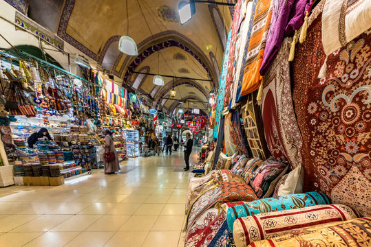 ISTANBUL, TURKEY- APRIL 17, 2017: Unidentified Tourists visiting and shopping in the Grand Bazaar in Istanbul.Interior of the Grand Bazaar with Turkish  rug and carpet on the front side.