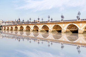 View on the famous saint Pierre bridge with reflection on the water in Bordeaux city, France