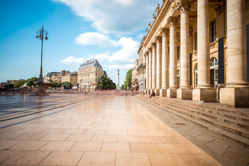 Fototapeta premium View on the square with Grand Theatre building in Bordeaux city, France. Long exposure image technic with motion blurred people and clouds