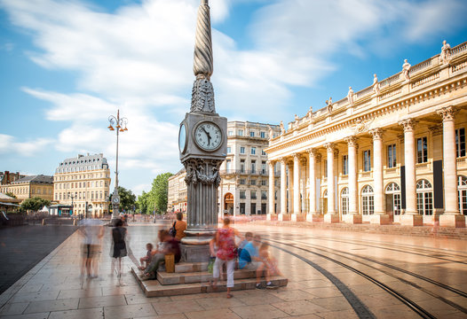 View on the square with Grand Theatre building in Bordeaux city, France. Long exposure image technic with motion blurred people and clouds