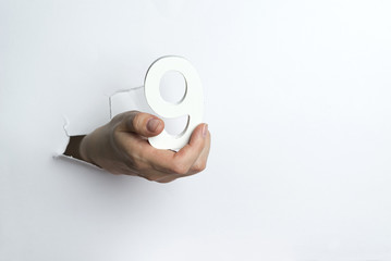 Woman's hand holding the number nine white background.