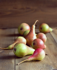 Pears on a rustic wooden background Beautiful fruit Vertical photo