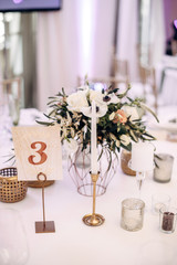 decorated table bride and groom with flasks for candles, flowers, candles and candlesticks