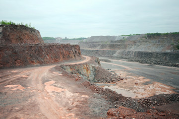 dirty road leading through a quarry mine