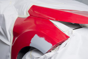 Auto body repair series: Red car after being masked waiting for repaint