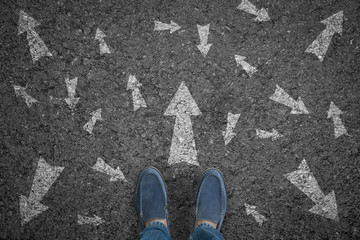 man standing on road with many direction arrow choices or move forward. concept solution and start.