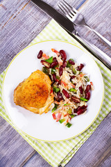 Chicken with Rice, Beans, Bacon and Green Pepper on White Plate. View from above, top studio shot