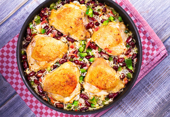 Chicken with Rice, Beans, Bacon and Green Pepper in Pan. View from above, top studio shot