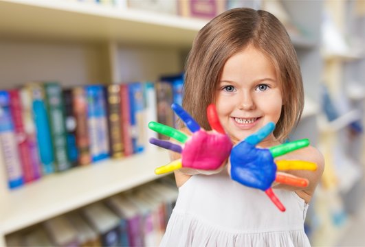 Child showing colorful hand.