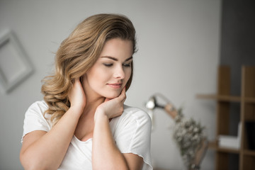 Naklejka premium portrait of charming blonde tender woman in white clothes