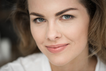 portrait of attractive smiling blonde woman looking at camera