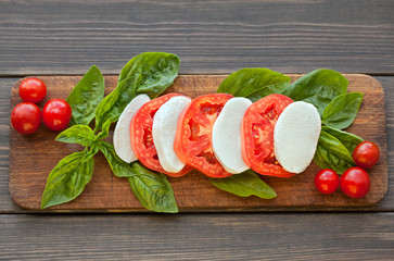 Caprese Salad. Tomato and Mozzarella slices with basil leaves.