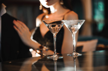 Two glasses of martini coctail in a bar