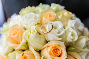 Wedding rings on wedding bouquet