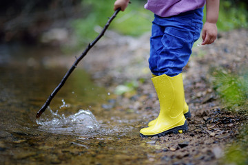Two pairs of color children's gumboots standing children