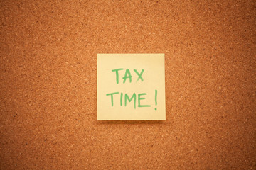 Tax time note on a cork board