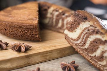 Homemade zebra pie on a wooden board and anise star