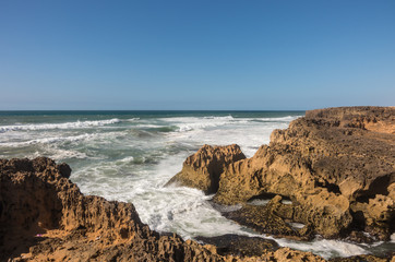 Fototapeta na wymiar Waves breaking of cliffs near Oualidia lagoon in same name village in Atlantic ocean coast, Morocco