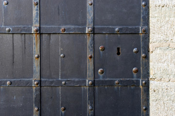 Iron painted door with keyhole, background with copy space for text.