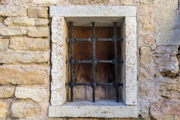 Fototapeta na wymiar Castle barred window. Medieval style window dirty 