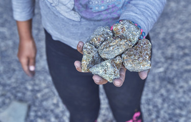 Beggar children sell the bits of chalcopyrite to foreign tourists