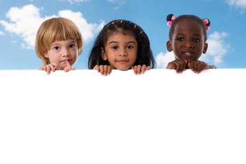 Group of multiracial kids portrait with white board