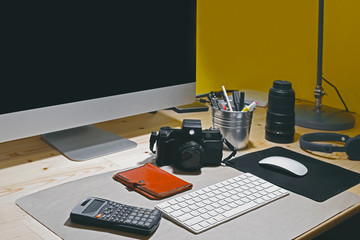 Naklejka premium Close up of workplace with blank computer screen and accessories