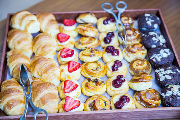 Colorful breakfast - homemade waffles, granola,muffins,almond,hazelnuts,various fresh fruits, berries on a old wooden table. Health food concept