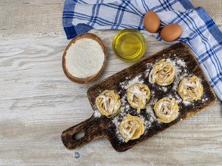 Italian homemade pasta on a wooden table. 