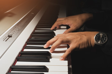 Obraz na płótnie Canvas Hand musician playing piano. vintage filter..