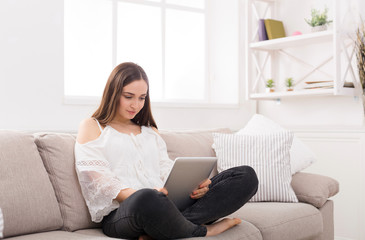 Fototapeta premium Young woman at home with tablet