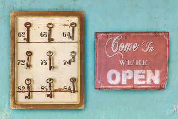 Small vintage cabinet with rusted hotel keys and open sign