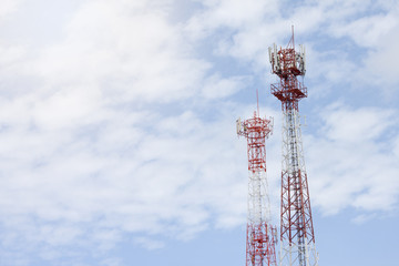 Two antenna tower with white cloud and blue sky on daytime.