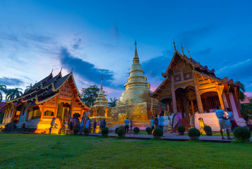Tourists are visiting at Wat Phra Singh Woramahaviharn in Chiangmai, Thailand at dusk on Asarnha bucha day. This is very famous local landmark of Chiangmai that lots of tourists have to be visited.