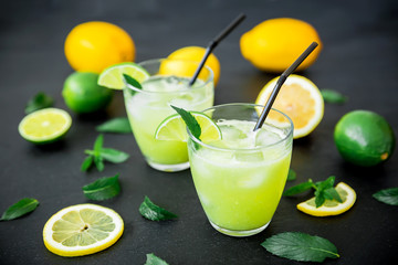Fresh citrus lemonade with limes and lemons in glasses