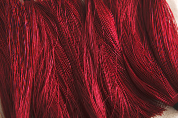 Red tassels background close up