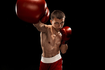 Male boxer boxing with dramatic edgy lighting in a dark studio